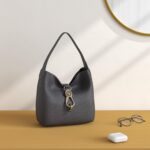 1747010755 dooney bourke womens small logo lock sac shoulder bag in pebble grain leather with signature logo lock closure.jpg