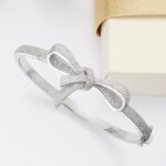 1747013106 ross simons 0.15 ct. t.w. diamond bow bangle bracelet in sterling silver. 7 inches.jpg