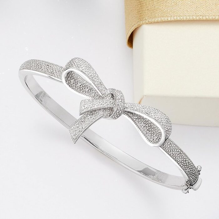 1747013106 ross simons 0.15 ct. t.w. diamond bow bangle bracelet in sterling silver. 7 inches.jpg