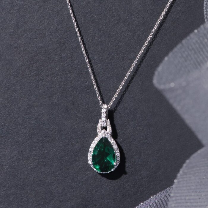 1747082106 jewelili 10k white gold 12x8mm pear created emerald ruby sapphire with round created white sapphire and natural white round diamond accent drop pendant necklace.jpg