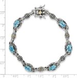 1747255938 jewels by lux sterling silver w14k gold swiss blue topaz bracelet.jpg