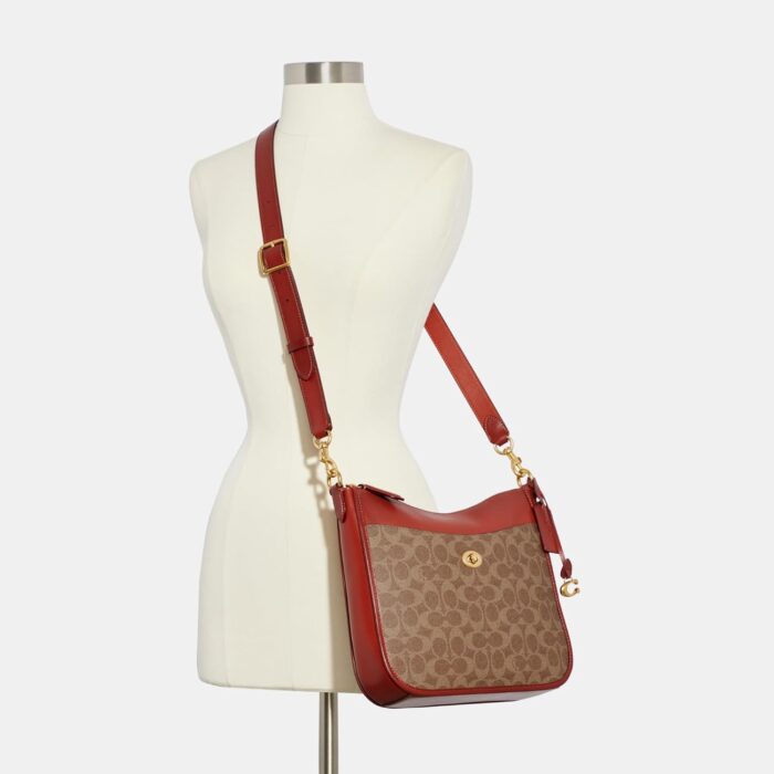 1747270494 coach coated canvas signature chaise crossbody tanrust.jpg