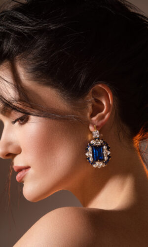 Elegant young woman with beautifully styled hair in studio